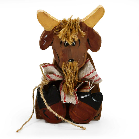Wooden goat figurine with a striped scarf on a white background