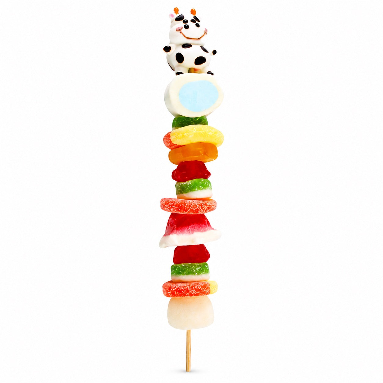 Cow candy kabob featuring a black-and-white cow candy topper and assorted fruit-flavored candies on a wooden skewer, isolated on a white background.