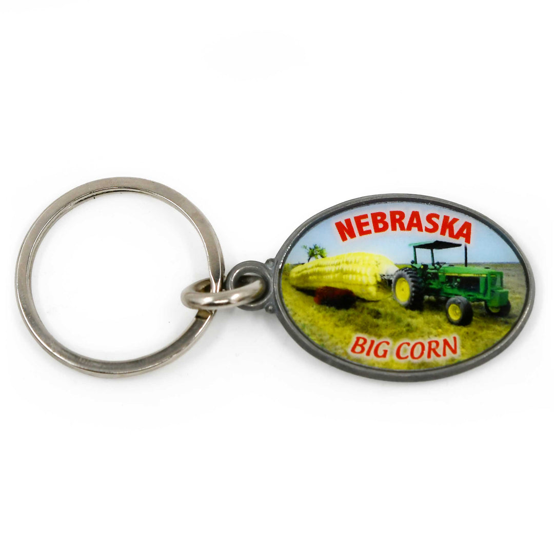 Keychain with a tractor and corn illustration and 'Nebraska Big Corn' text on a white background