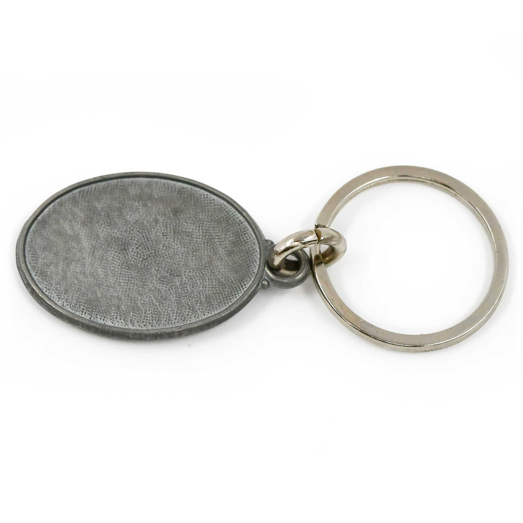 Metal keychain with textured surface on a white background