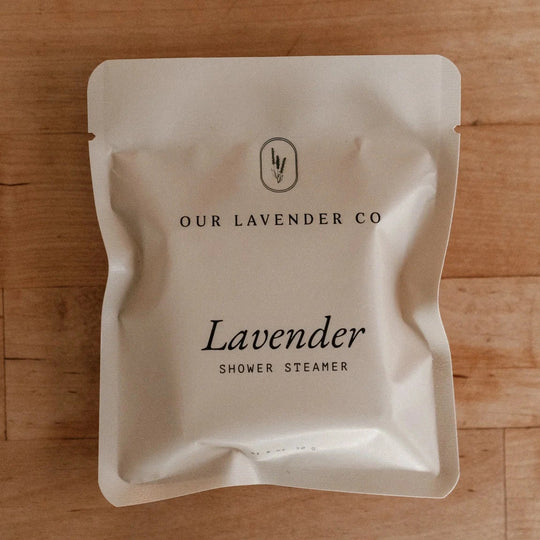 Lavender shower steamer packaging from Our Lavender Co on a wooden surface