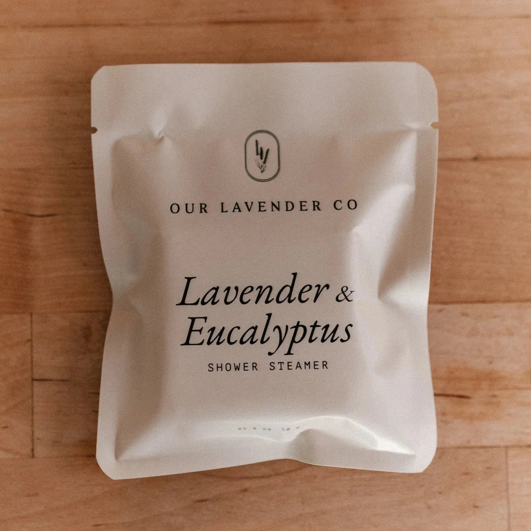 Shower steamer packaging with 'Our Lavender Co' branding on a wooden surface