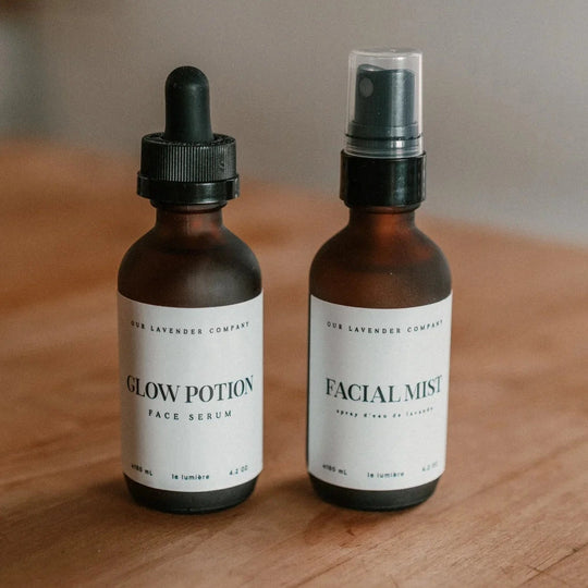 Two bottles labeled 'Glow Potion' and 'Facial Mist' on a wooden surface.