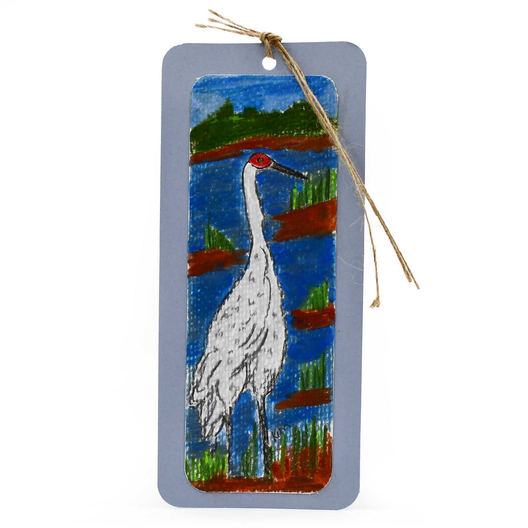 Decorative bookmark with a painted crane design on a white background