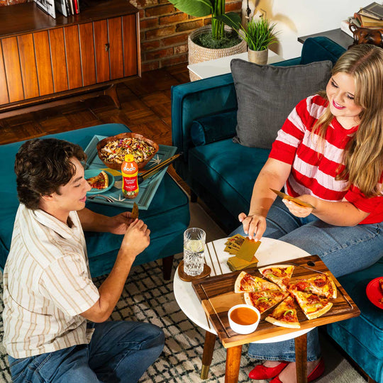 Couple enjoying cards and pizza with dorothy lynch