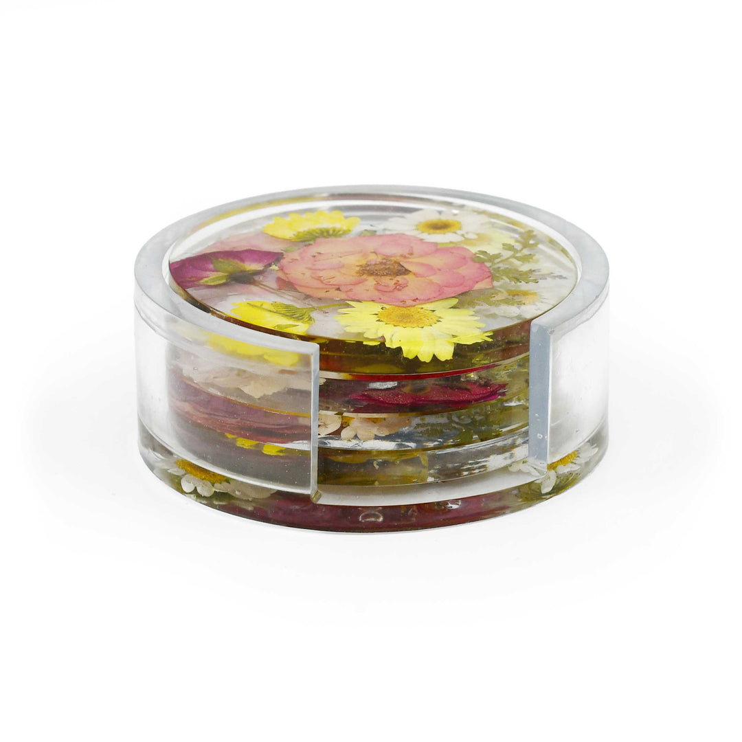 A clear acrylic round container with a lid, filled with dried flowers and botanical pieces, photographed on a clean white background.