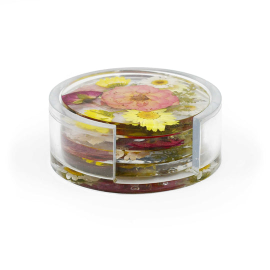 A clear acrylic round container with a lid, filled with dried flowers and botanical pieces, photographed on a clean white background.