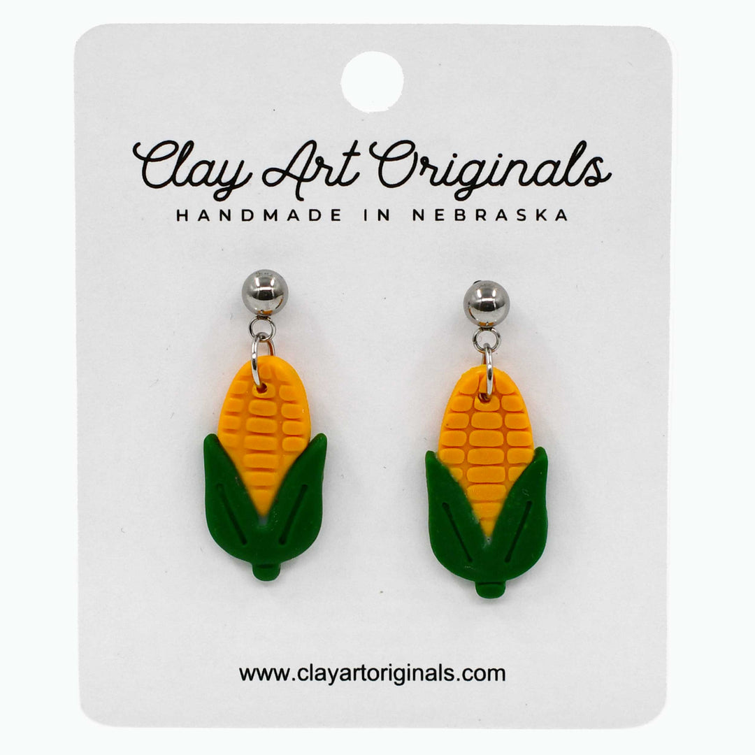Corn-shaped earrings on a Clay Art Originals card
