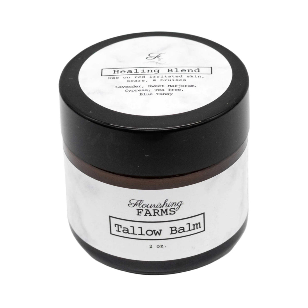 Tallow balm jar with black lid and white label on a white background