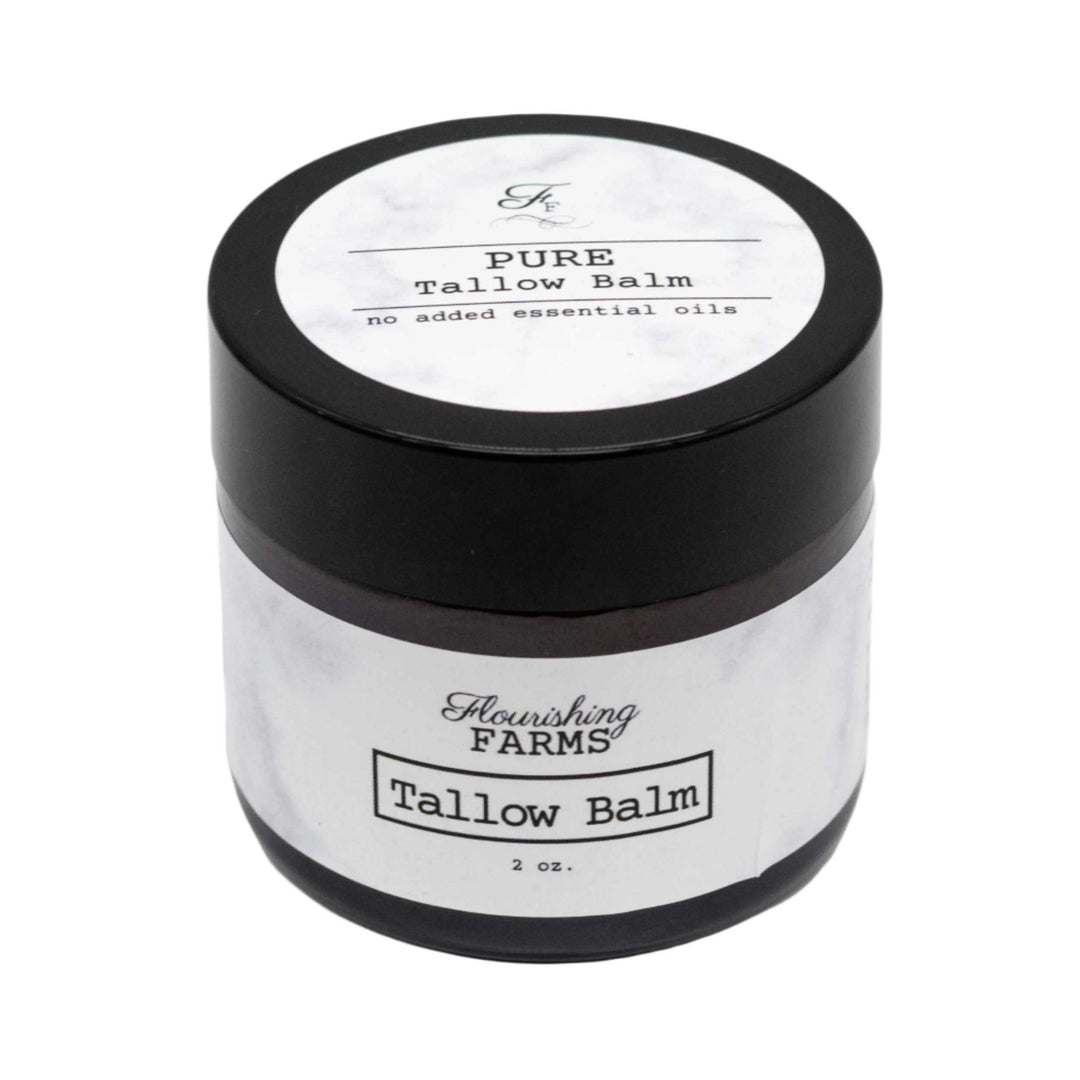 Tallow balm jar with black lid and white label on a white background