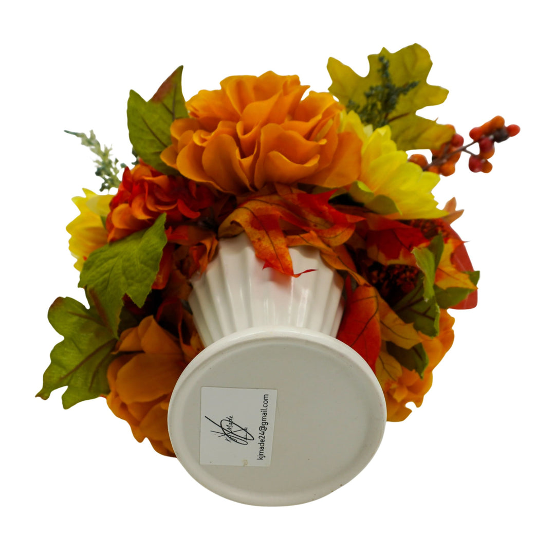 Decorative wreath with autumn leaves and flowers on a white background