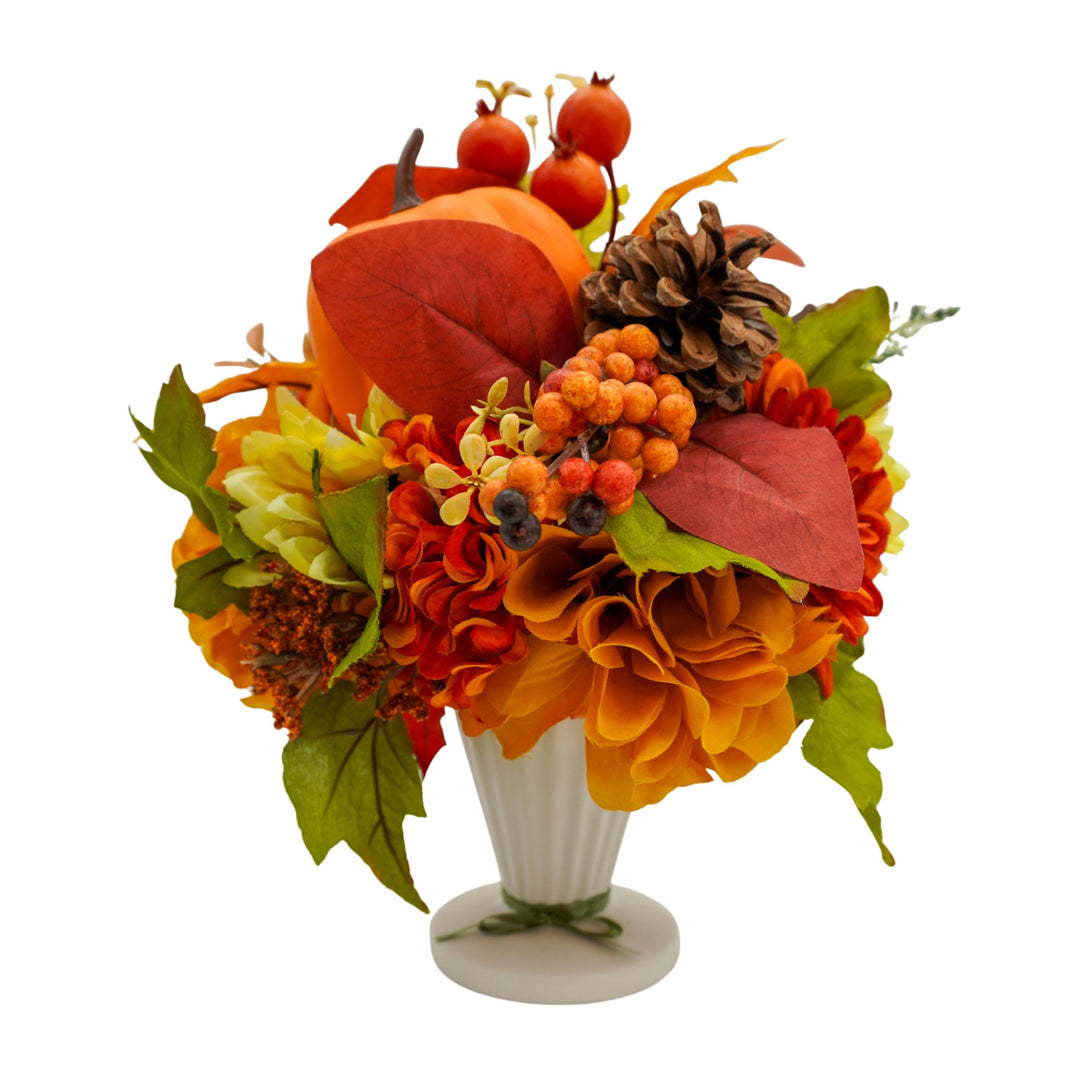 Autumn-themed floral arrangement with pumpkins, berries, and leaves in a white vase on a white background