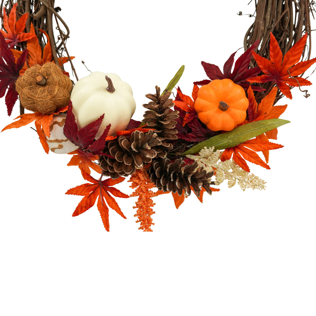 Decorative wreath with pumpkins, leaves, and pinecones on a white background