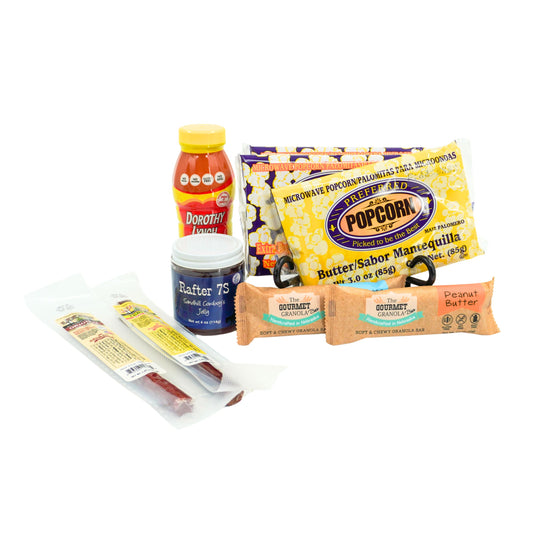 Assorted snacks including a bottle, popcorn, and bars on a white background