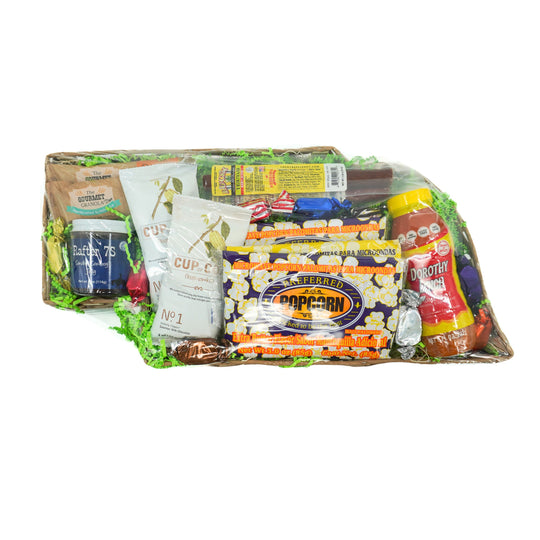 Gourmet gift basket with snacks and drinks on a white background