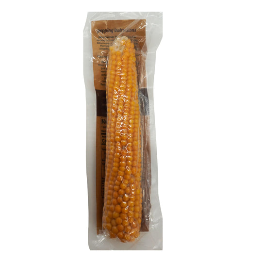 Packaged corn on the cob with a clear plastic wrap on a white background
