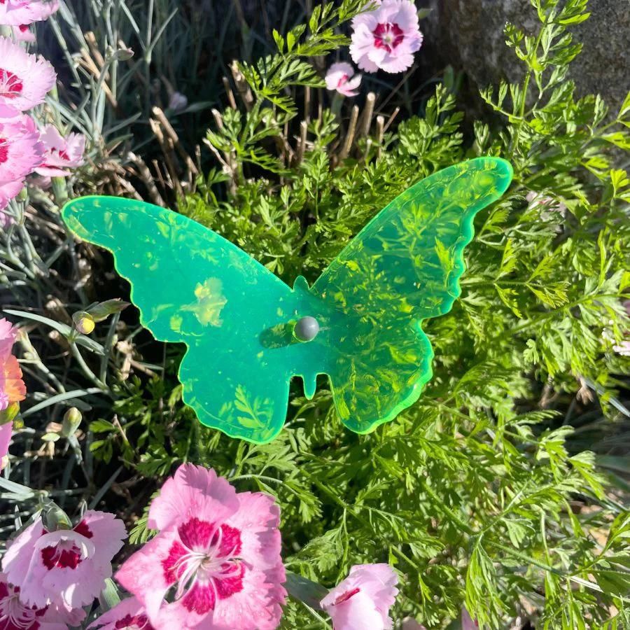 A green glowing butterfly in grass