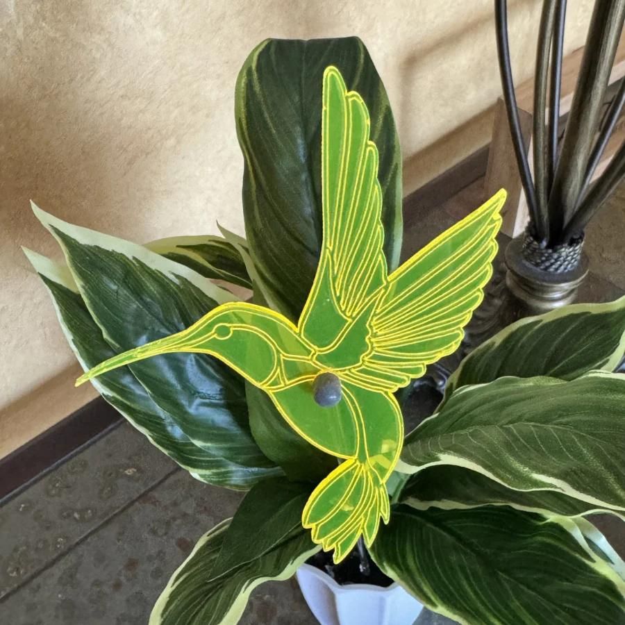 A yellow glowing hummingbird in leaves