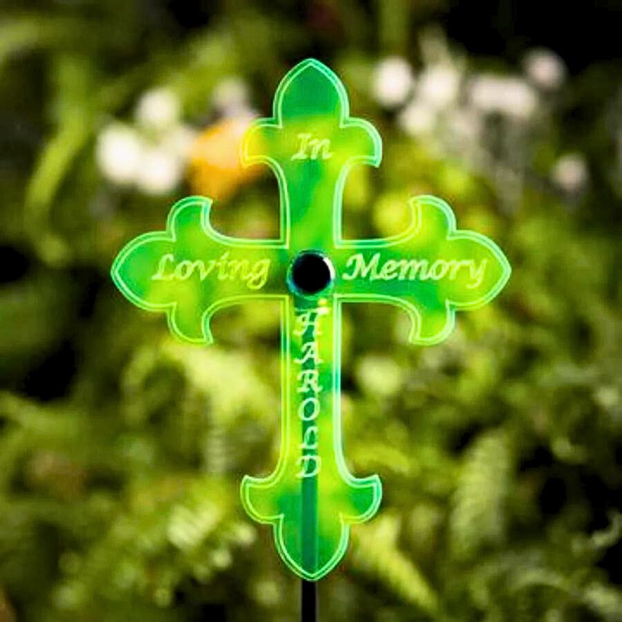 A glowing custom: "In Loving Memory" cross on a leafy background