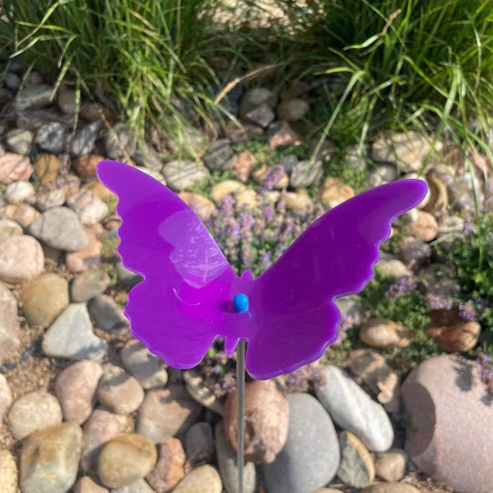 A purple glowing butterfly in rocks