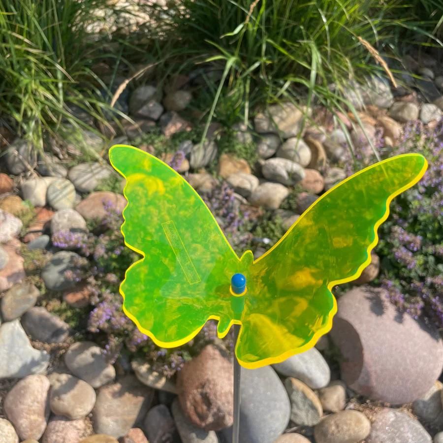 A yellow glowing butterfly in rocks