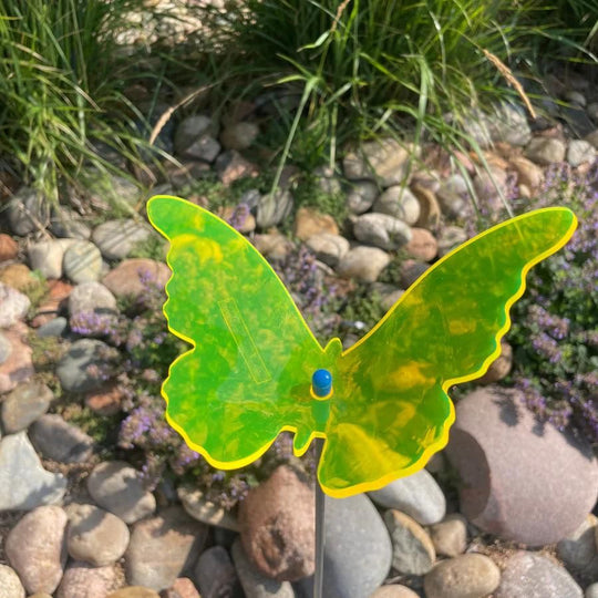 A yellow glowing butterfly in rocks