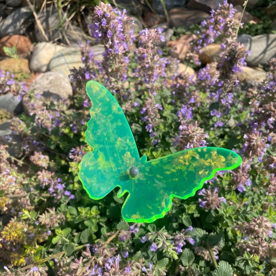 A green glowing butterfly in flowers