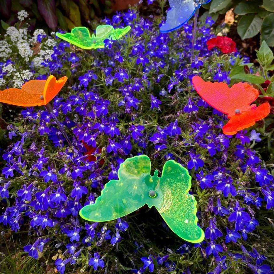 A variety of glowing butterflies in flowers