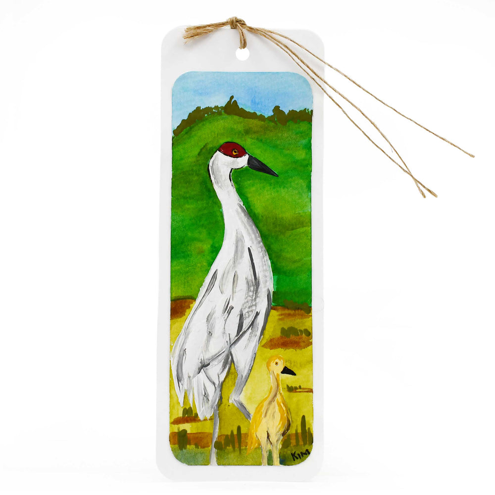 Bookmark with a painting of two cranes against a scenic background