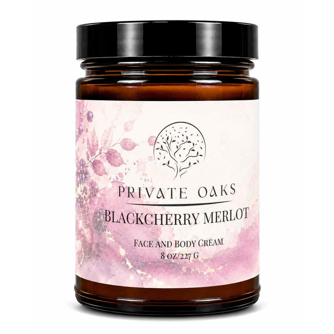 A jar of Private Oaks Blackberry Merlot Face and Body Cream, featuring an amber glass jar with a black lid and a pink watercolor floral label.