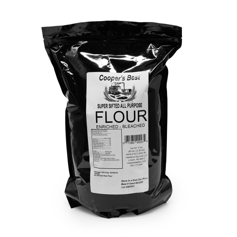A 5 lb bag of Cooper's Best Premium Sifted All Purpose Flour in a black package with a label.