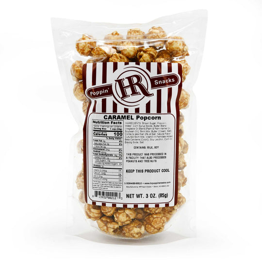 Bag of caramel popcorn with a label on a white background