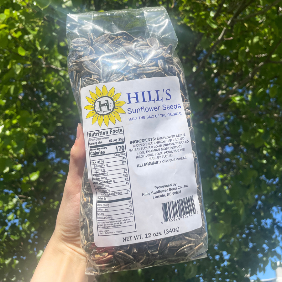 Front angle image of Half Salt Sunflower Seeds Bag with Tree in background