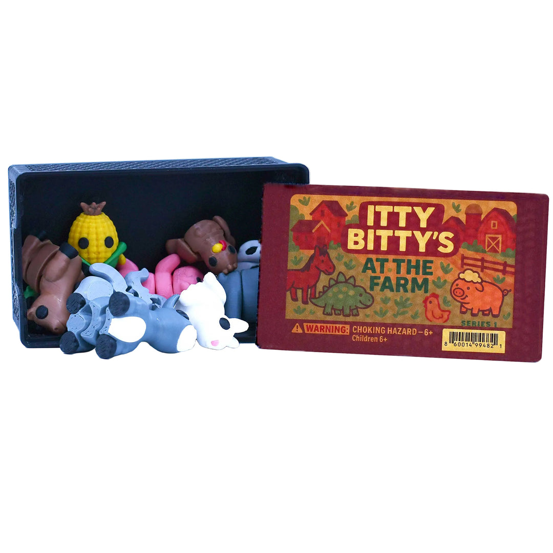 Set of small animal figurines in a box with 'Itty Bitty's at the Farm' book on a white background