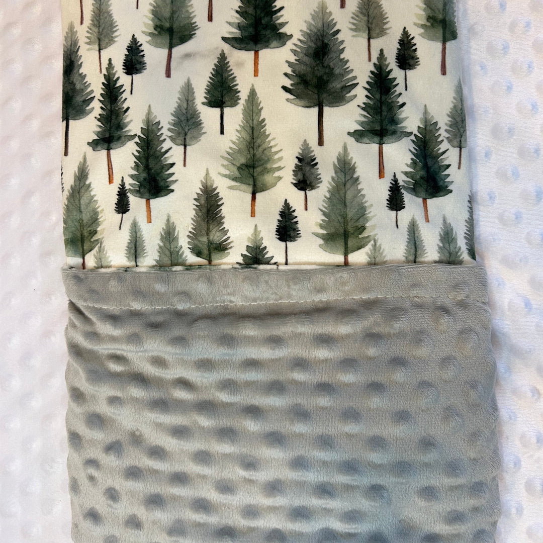 Fabric with tree pattern and gray pocket on a textured background