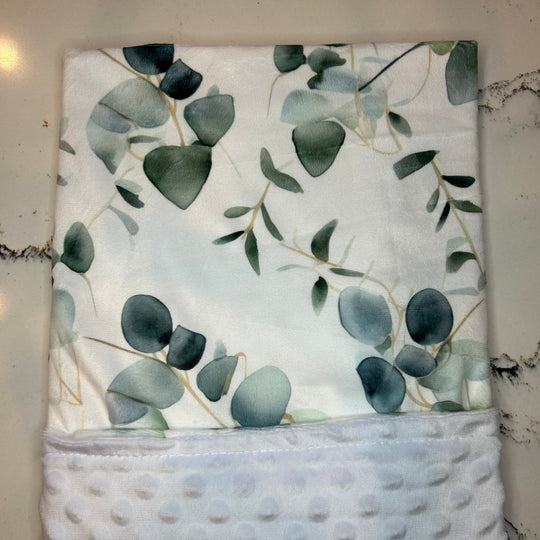 Floral-patterned fabric with green leaves on a white background