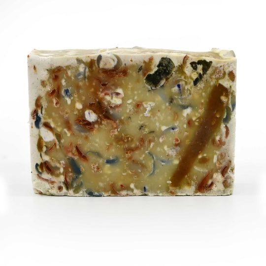 Bar of soap with visible ingredients on a white background