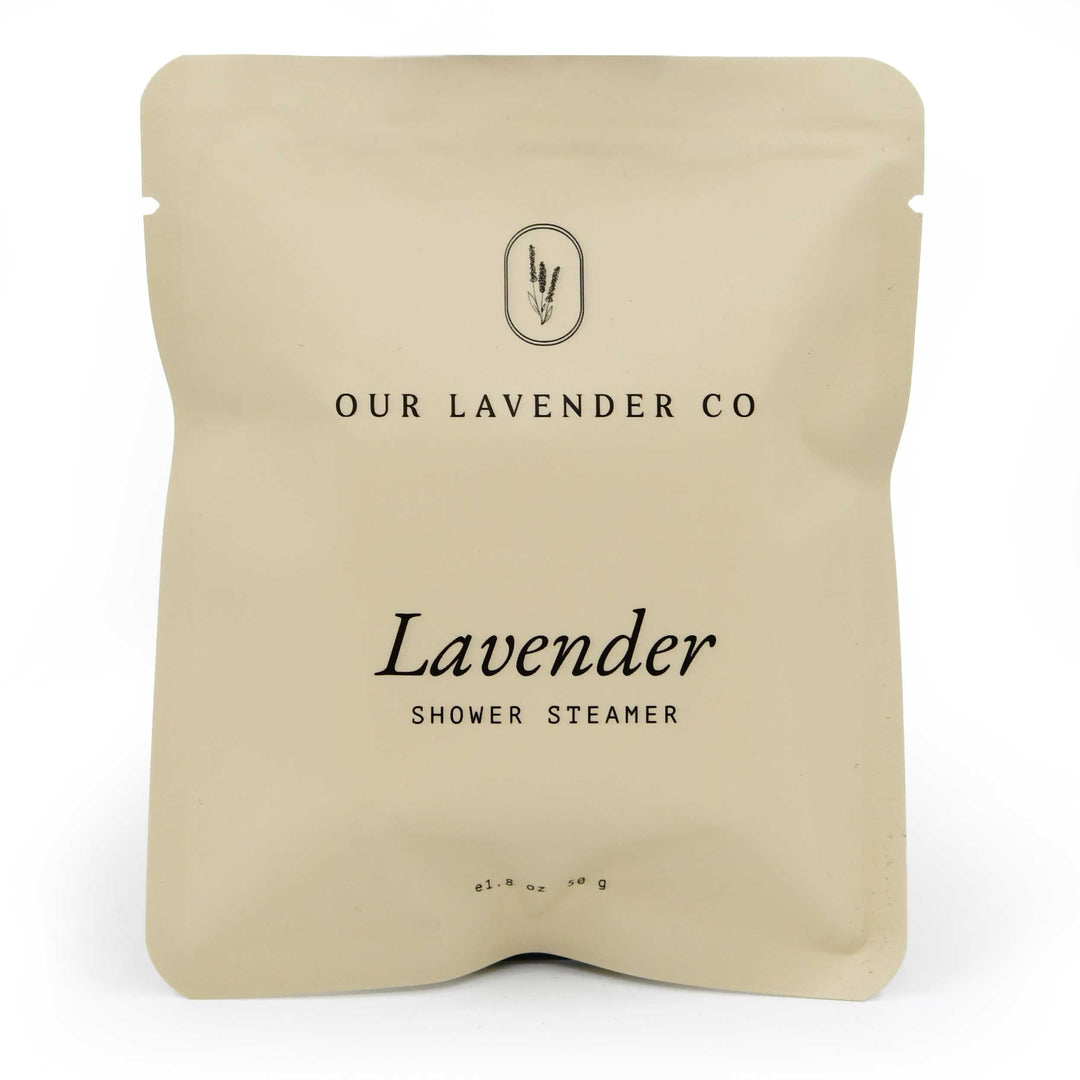 Beige packaging of a lavender shower steamer from Our Lavender Co on a white background
