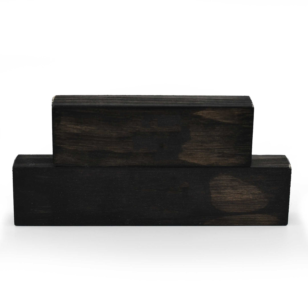 Two dark wooden blocks on a white background