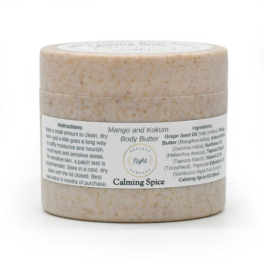 A jar of Mango and Kokum Body Butter in Calming Spice scent, featuring a speckled beige product inside a clear jar with a white label, set against a plain white background.