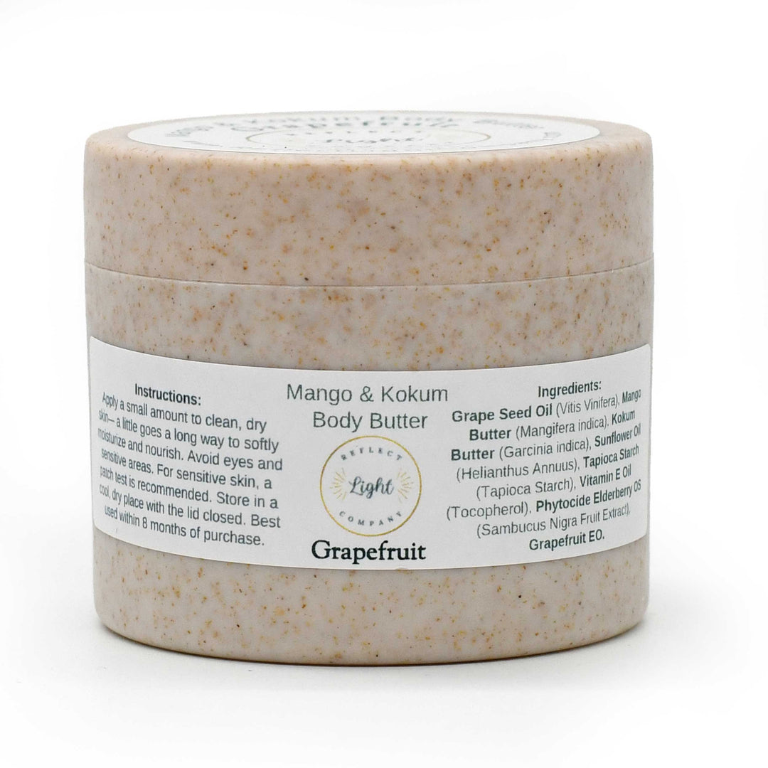 A jar of Grapefruit Mango & Kokum Body Butter by The Light Brand, featuring a speckled beige textured container and a white label with black text, set against a plain white background.