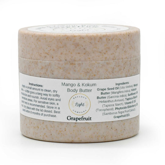 A jar of Grapefruit Mango & Kokum Body Butter by The Light Brand, featuring a speckled beige textured container and a white label with black text, set against a plain white background.