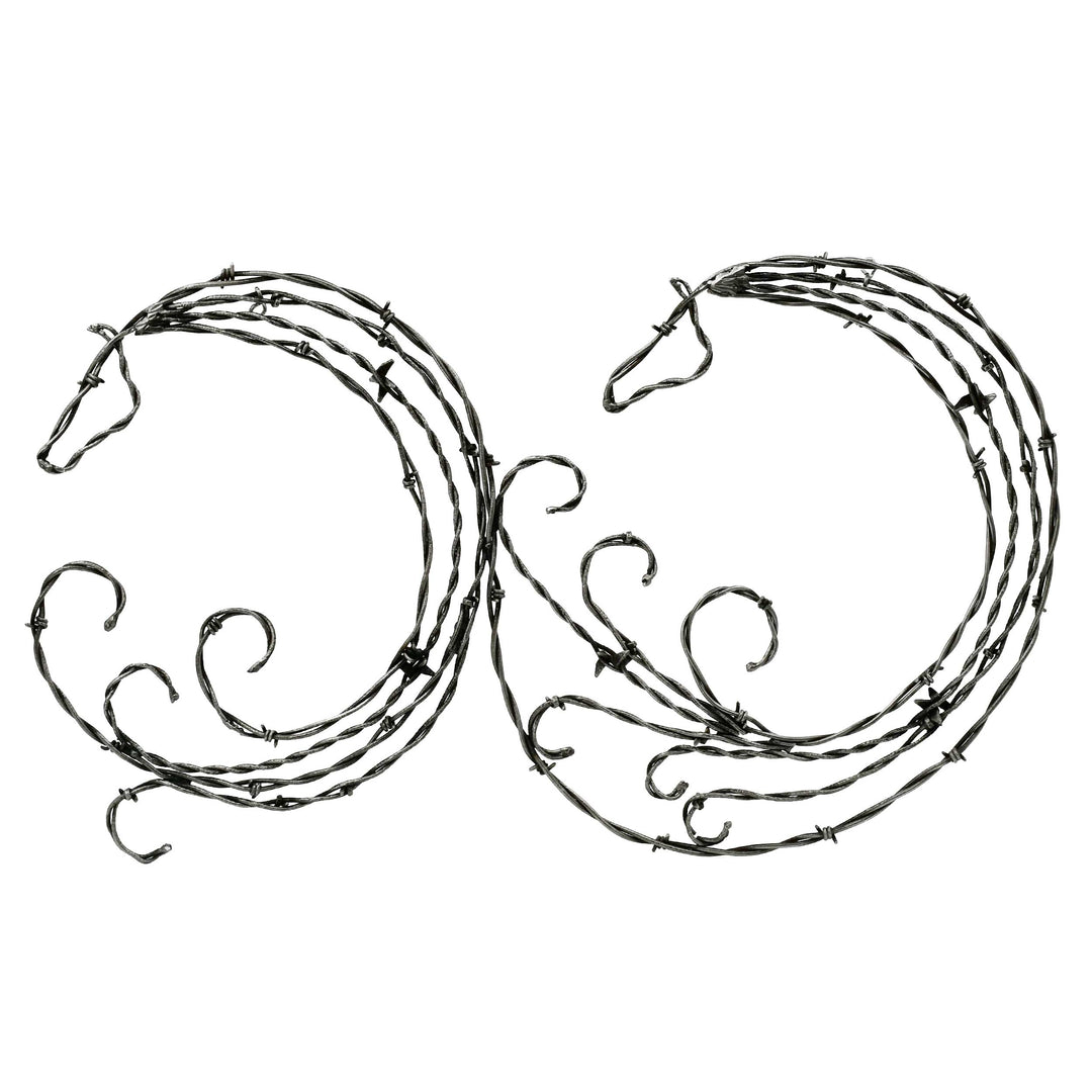 Decorative metal horse head sculptures on a white background