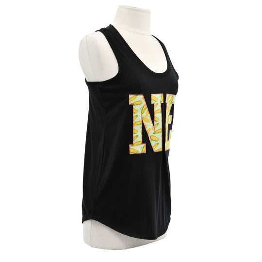 A black sleeveless tank top displayed on a white mannequin torso against a plain white background. The front features a large decorative letter 'N' filled with a yellow, green, and white tropical leaf pattern.