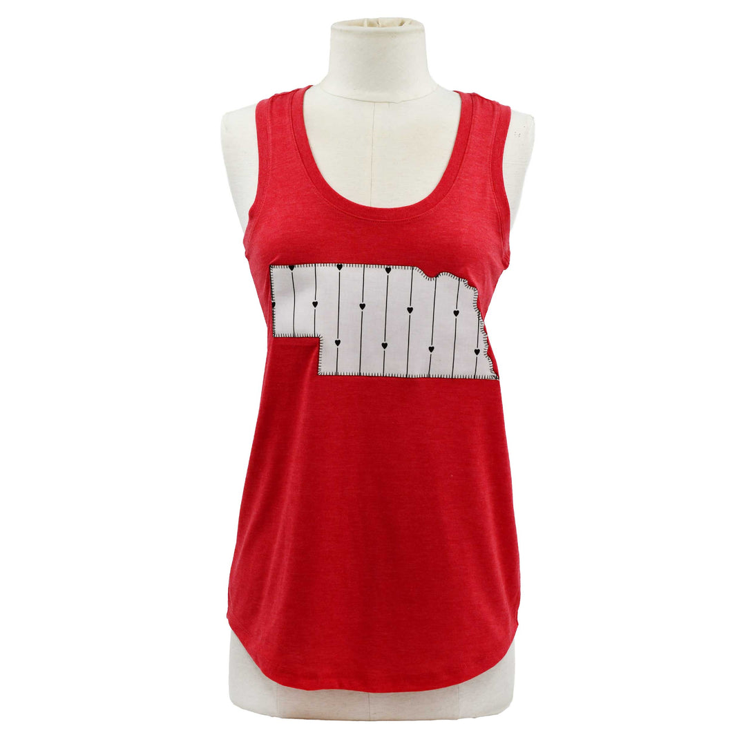 A red sleeveless tank top displayed on a white mannequin torso against a plain white background. The top features a white rectangular chest panel with thin black vertical lines and small black dots.