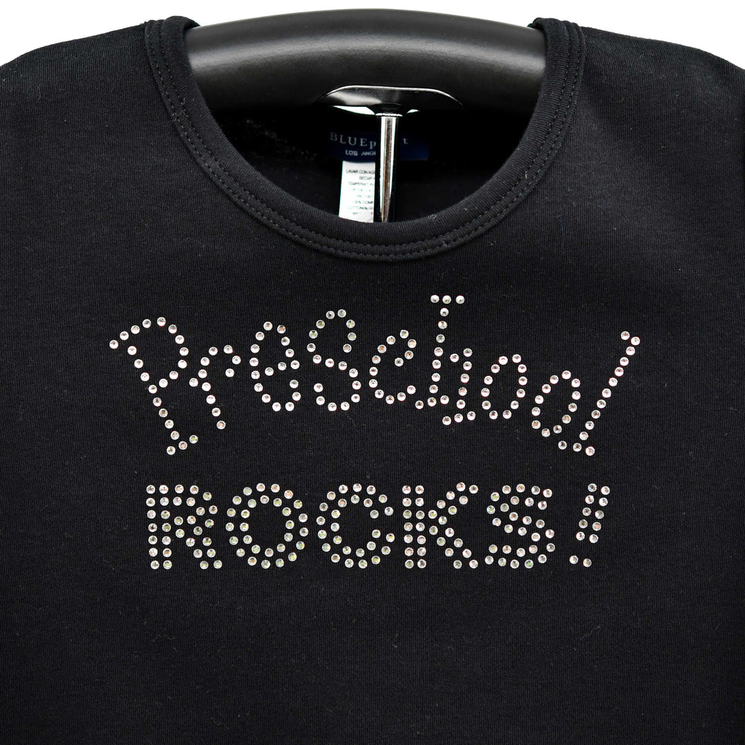 Black sweatshirt with 'Preschool ROCKS!' text in rhinestones on a hanger.