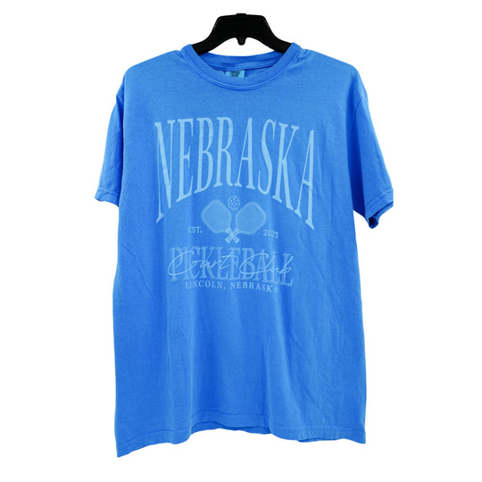 Blue t-shirt with 'Nebraska Pickleball' text on a white background