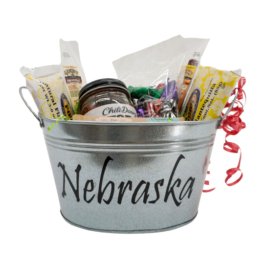Metal bucket labeled 'Nebraska' filled with snacks and treats on a white background