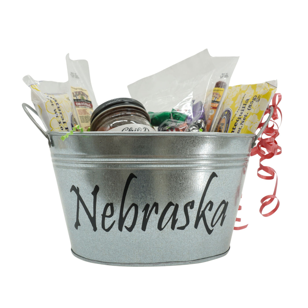Metal bucket labeled 'Nebraska' filled with snacks and gifts on a white background