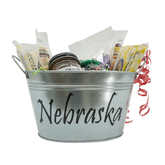 Metal bucket labeled 'Nebraska' filled with snacks and gifts on a white background
